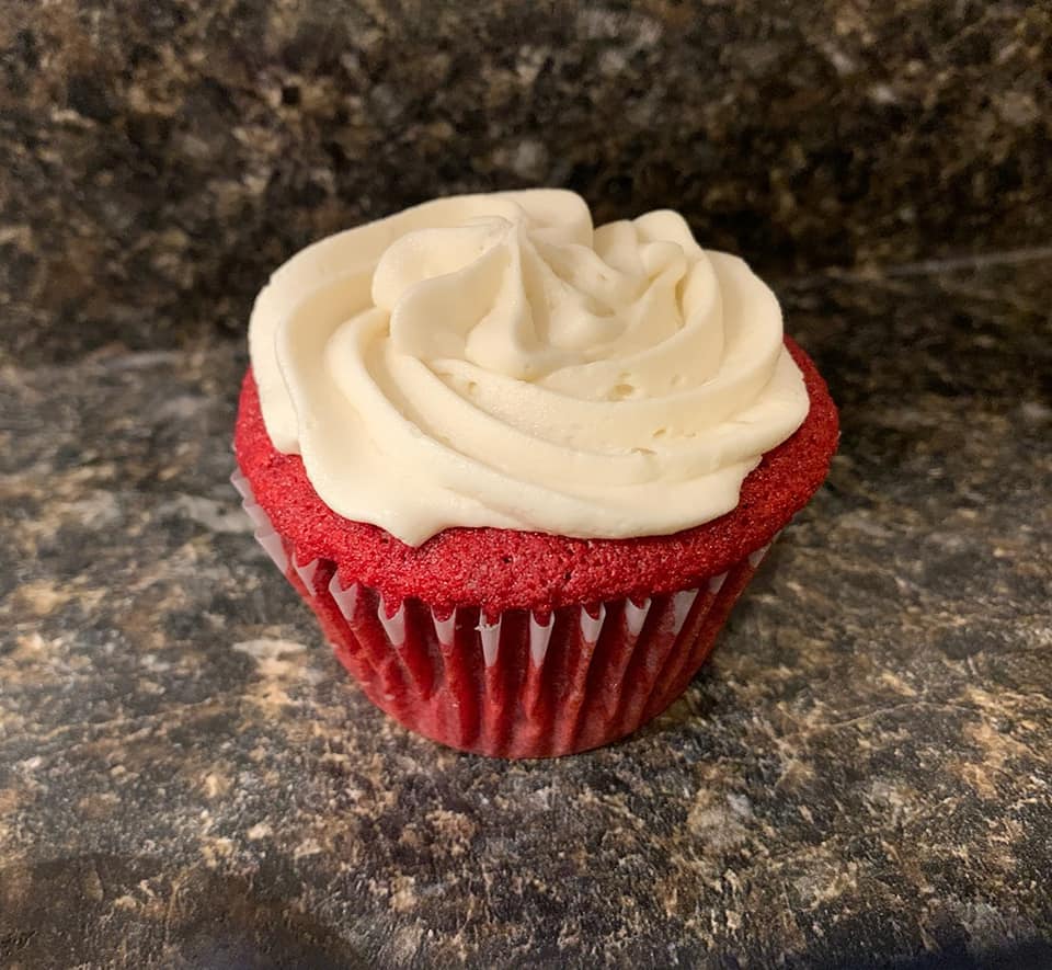 Red velvet cupcake with white swirling frosting