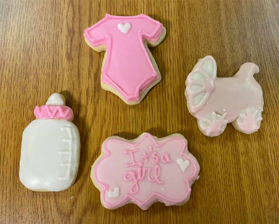 picture of gluten-free cutout sugar cookies decorated in pink and white for a baby girl shower event