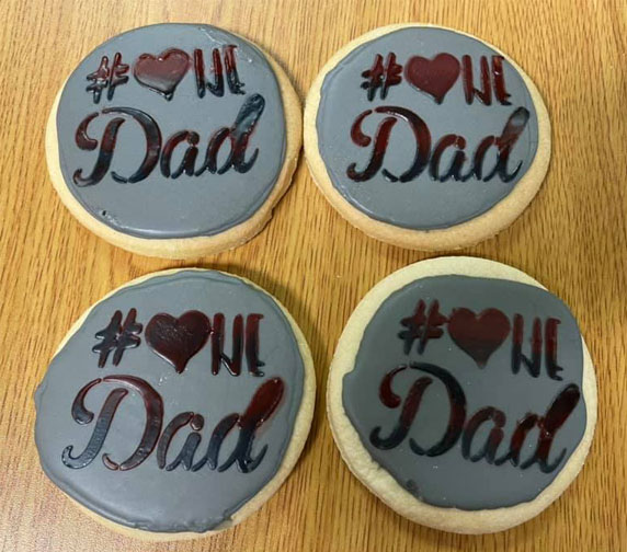 Father's day gluten-free round cutout sugar cookies with grey frosting and decoration saying # heart dad