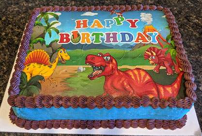 Gluten-free birthday cake decorated with dinosaurs