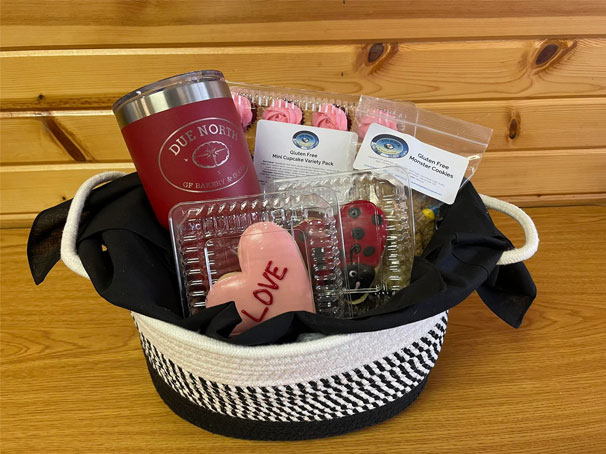 Due North Gluten-Free Bakery gift basket with an insulated coffee cup and a variety of gluten free cookies