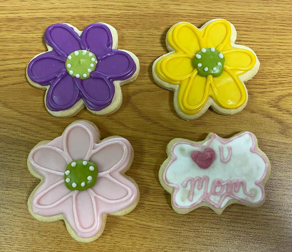 picture of gluten-free cutout sugar cookies decorated as flowers for mother's day
