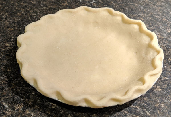 photo of gluten-free pie crust in a tin